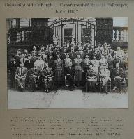 Group photograph of the Department of Natural Philosophy, at the gates of what is now the School of Geosciences, Drummond Street. Photograph taken in June of 1957. Present, from top left to bottom right, are W. H. Stevens, J. M. Ferguson, L. Kennedy, W. B. Wilson, C. McAnna, B. O'Keffe, G. Burt, A. G. A. Rae, R. Haldane, D. Hall, K. A. Robertson, A. Binnie, J. B. McInnes, R. M. Hudson, J. P. Sah, J. Ferreira, A. Headridge, R. Sinclair, T. Murray, D. F. Thompson, R. Allan, D. Blackburn, L. W. Barr, J. Muir, D. N. Davies, R. A. Donald, I. L. Fairweather, E. J. Williams, M. McInally, S. W. Peat, D. Craigie, R. Galloway, Margaret D. Wilson, Joan M. McRobbie, Mrs Davidson, Doris Brewster, Agnes McMillan, Margaret Buchan, Mar Y. Smith, V. Anne Briglmen, Mrs Smith, D. H. McIntosh, R. M. Sillito, Dr. A. F. Brown, Dr. G. R. Evans, Mr J. Paton, Professor N. Feather, Dr Marion Ross, Mr J. Kyles and Dr R. D. Connor.